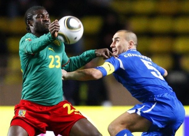 Italy defender Fabio Cannavaro, right, challenges for the ball with Cameroon forward Dorge Kouemaha during the international friendly soccer match between Italy and Cameroon at the Louis II stadium in Monaco, Wednesday, March 3, 2010. (AP Photo/Antonio Calanni)